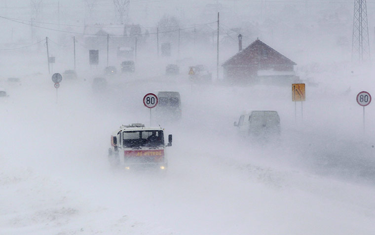 Europe weather: A truck drives through heavy snow falls near the town of Obilic, Kosovo
