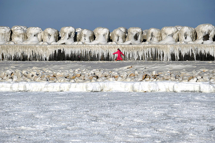 Europe weather: A girls run next to an ice covered dam in Constanta, Bucharest