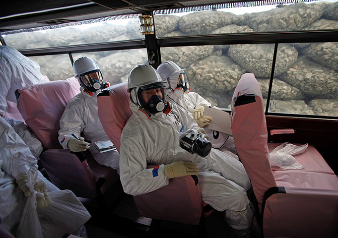 inside Fukushima: members of the media are driven past sea defences