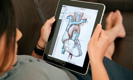 close up of woman using iPad digital tablet computer to study human anatomy using Grey's Anatomy app