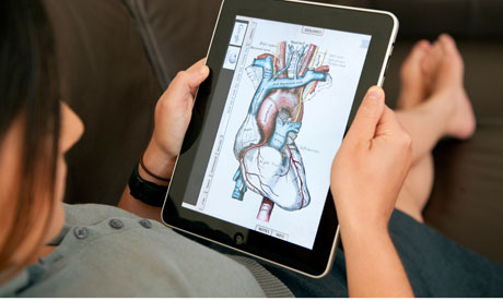 close up of woman using iPad digital tablet computer to study human anatomy using Grey's Anatomy app