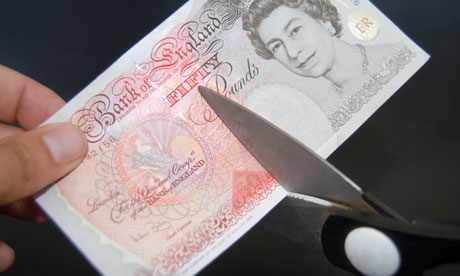 Fifty pound note being cut with scissors.. Image shot 2009. Exact date unknown.