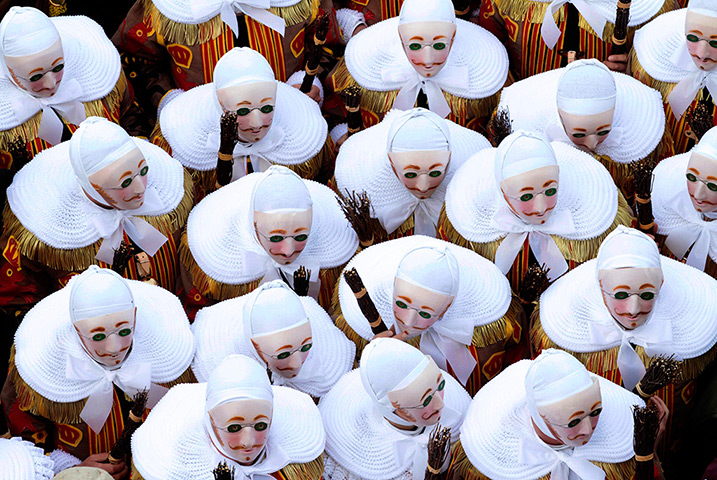 24 hours in pictures: the traditional Gilles of Binche dance during a carnival parade in belgium