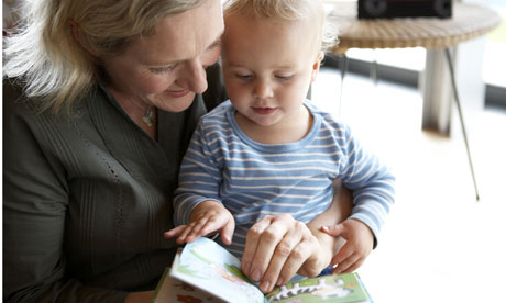 Older mother reads to her baby son