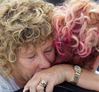 People embrace during the earthquake anniversary remembrance event in Christchurch.