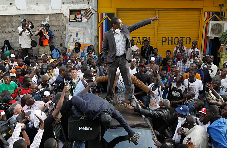 24 hours in pictures: Senegalese music star Youssou Ndour gestures as he rallies supporters