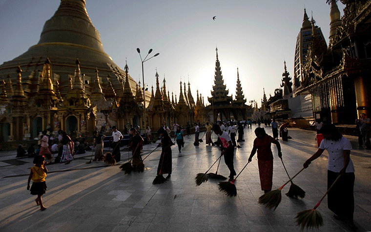 24 hours in pictures: Volunteers sweep the compound of Shwedagon Pagod, Burma