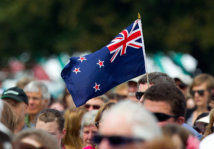 Christchurch memorial: A man holds a New Zealand flag