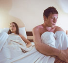 Unhappy couple in bed