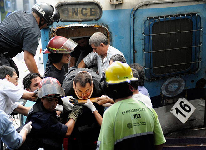 Buenos Aires Train Crash: Train crash in Buenos Aires: Rescue workers help a passenger 