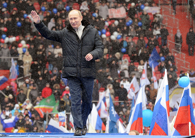 Putin presidential rally: Vladimir Putin waves to supporters during a rally at the Luzhniki stadium