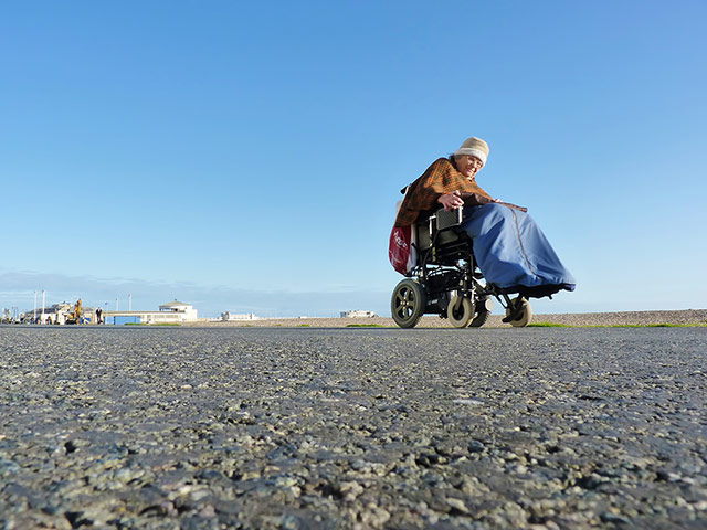 Weekend Readers Pictures: woman in an electric wheelchair by Pete Holmes 