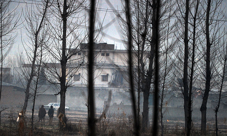 bin laden compound: Pakistani policemen stand guard beside the compound  while it is demolished