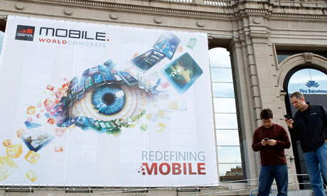 People walk by the Mobile World Congress main entrance in Barcelona