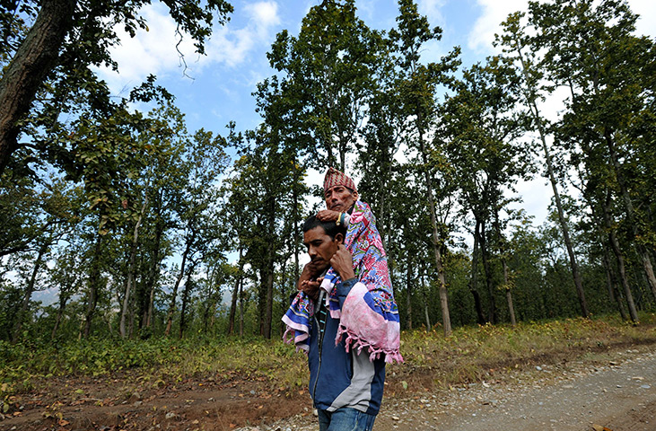 World's shortest man: Chandra Bahadur Dangi is carried by his nephew