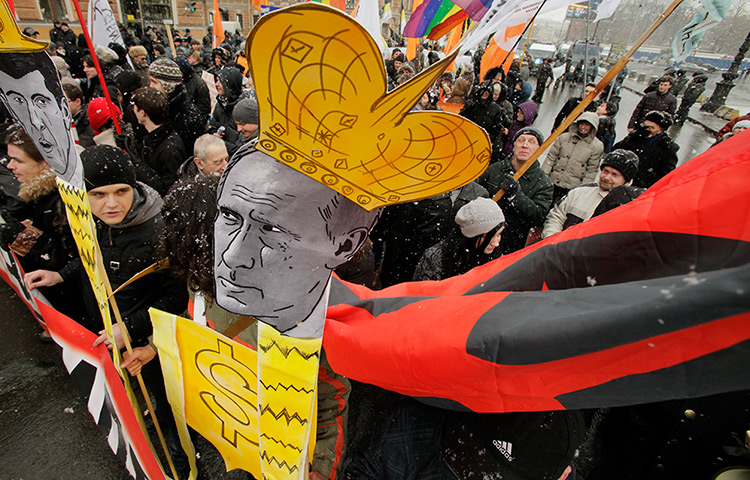Anti-Putin protests: Protesters carry a mock portrait of Russian Prime Minister Vladimir Putin