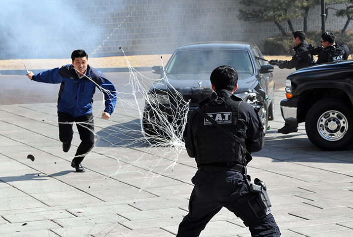 South Korea security: A presidential bodyguard shoots a net at a 