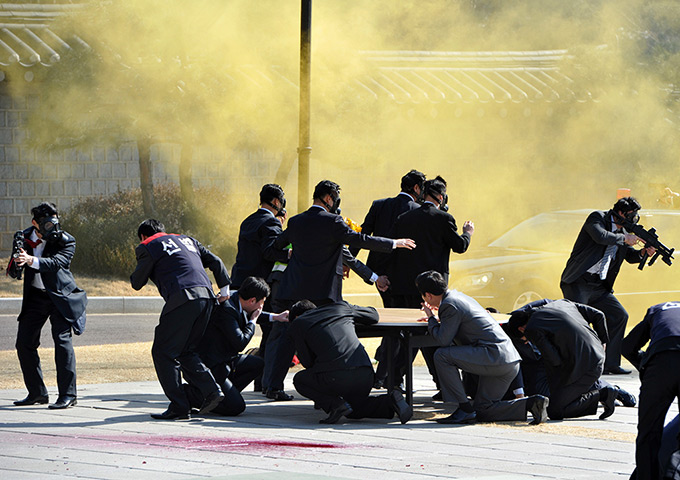 South Korea security: Presidential bodyguards wearing gas masks stage an anti-terror drill 