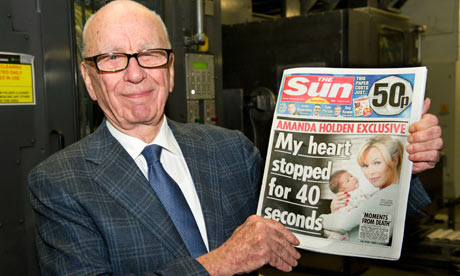 The Sun ... he loves it: Rupert Murdoch with the first edition of his new baby