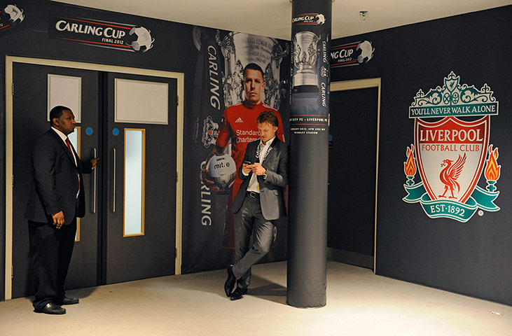 Carling Cup: Dirk Kuyt wearing his winners medal, sends a text message