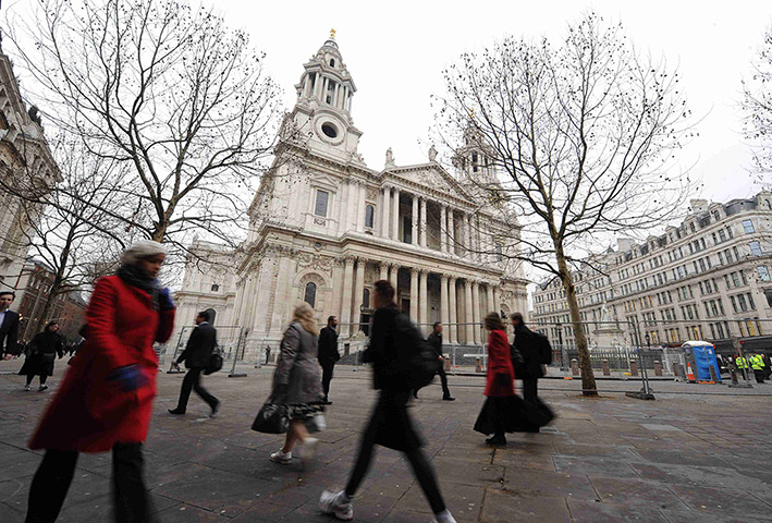 Occupy London eviction: City workers walk past the empty plaza in front of St Paul's Cathedral