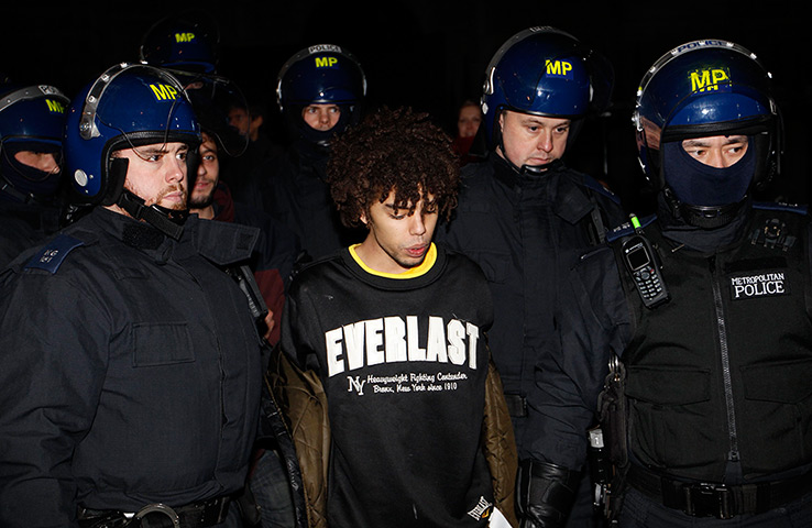 Occupy London eviction: Riot police escort a detained protester to waiting police vans