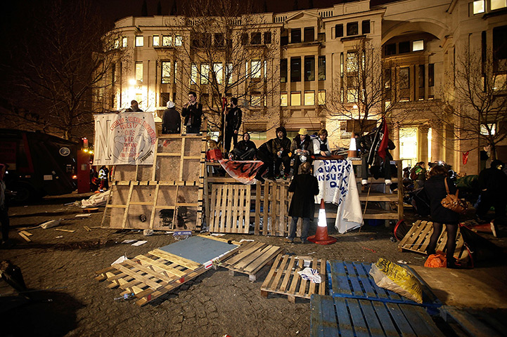 Occupy London eviction: Protesters stand on a barricade they constructed of packing crates