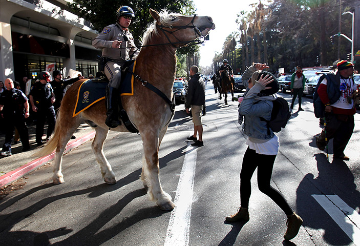  24 hours: Sacramento, California, USA: A mounted officer moves Occupy protesters