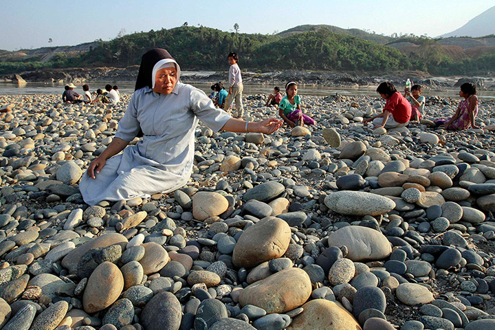  24 hours: Myitsone, Burma: A Catholic nun and convent students collect stones