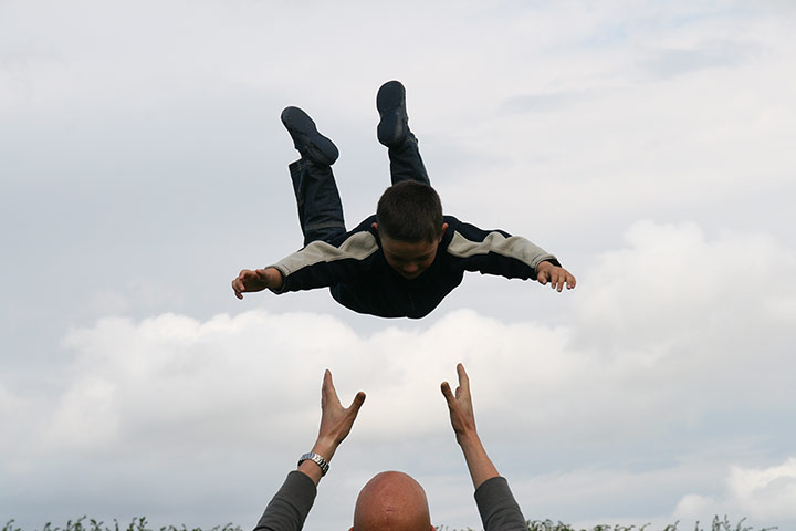 Readers' Pictures: young boy being thrown into the air by his father