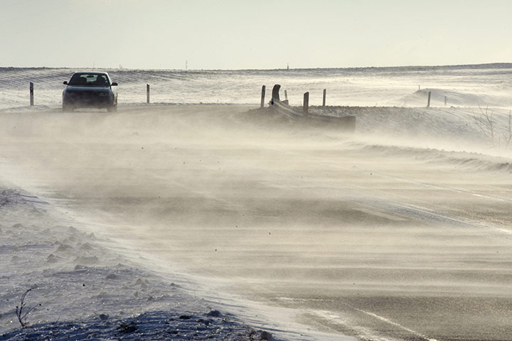 Weather: A car drives through the wind and snow in Penthaz, Switzerland