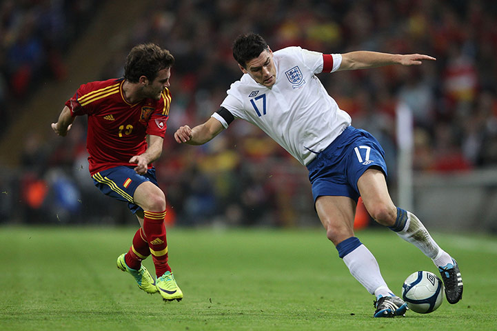 England Captains: Juan Mata of Spain and Gareth Barry of England compete for the ball