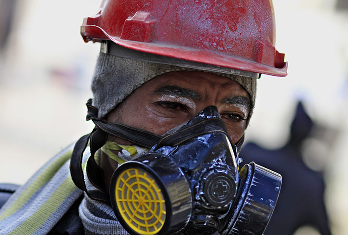 Egypt clashes: A protestor wears a protective mask during the clashes