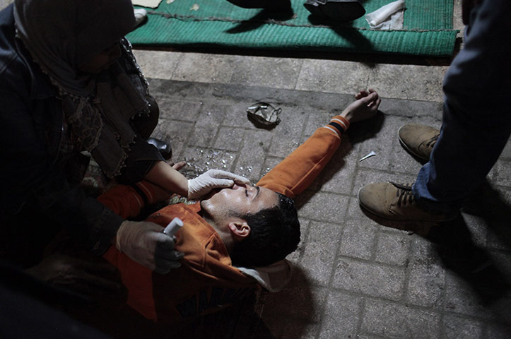Egypt clashes: A protester suffering from the effects of tear gas inhalation