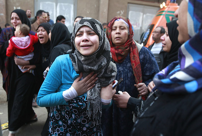 Egypt clashes: Relatives of victims killed in Port Said stadium wait outside a morgue