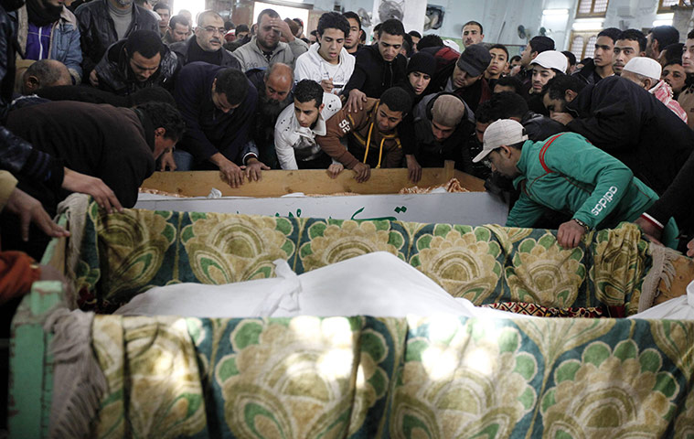 Egypt clashes: Mourners carry the bodies of victims of the violence during their funeral