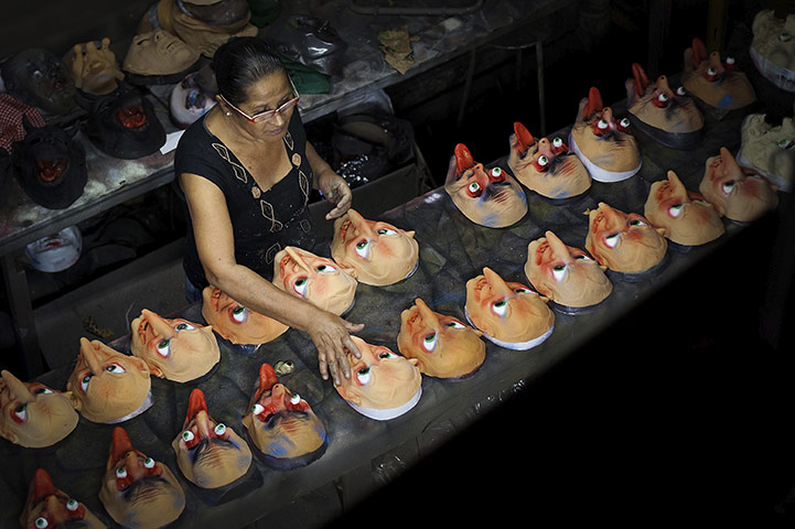 24 hours in pictures: Artists work on masks prior to the Carnival at Condal Masks Factory, Brazil