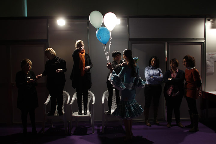 24 hours in pictures: A model holds balloons backstage in Seville