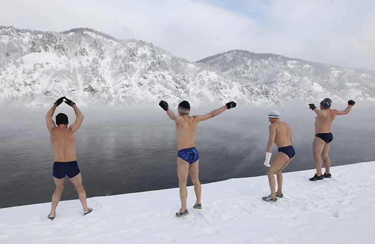 24 hours in pictures: A swiming club warm up on the bank of the Yenisei River