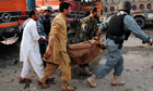 An Afghan civilian is carried away after being killed in a bomb attack in Jalalabad