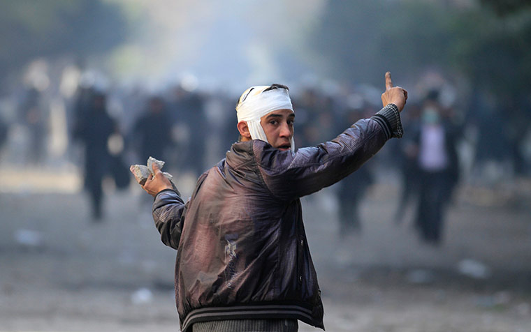 Egypt Protests: An Egyptian protestor holds stones during the clashes with security forces