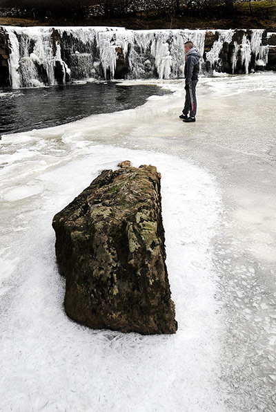 24 Hours: Ice partially covers the River Swale near Reeth