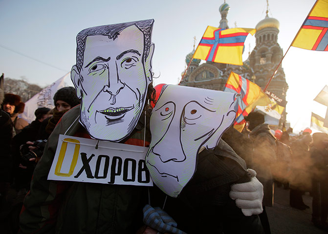 Russia Protest: Demonstrators wearing mock mask depicting Mikhail Prokhorov and Putin