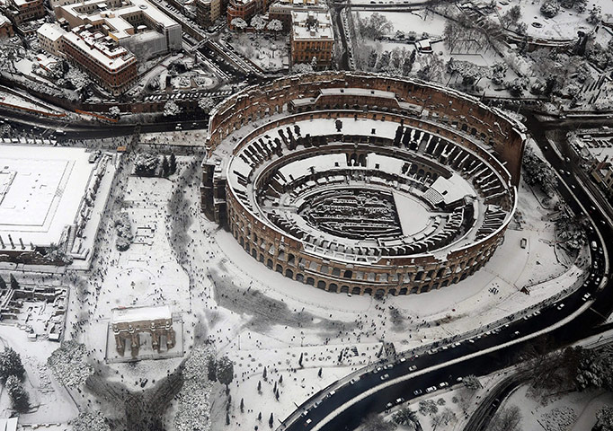 24 hours: Rome, Italy: An aerial view of the Colosseum after snow
