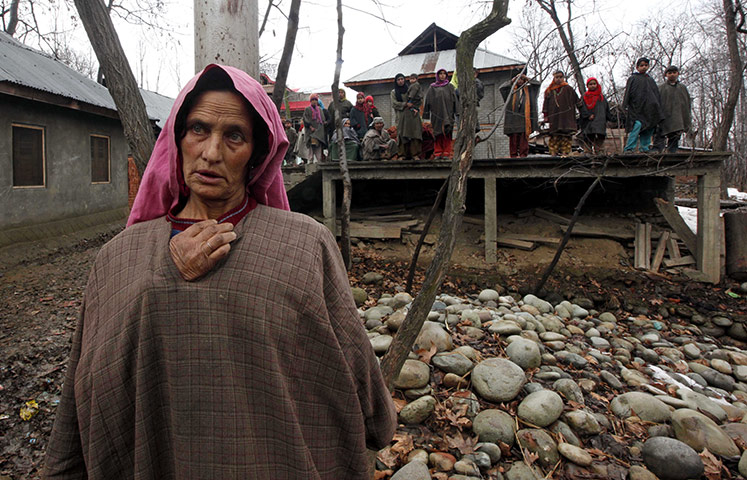 24 hours: Woodder, India: A Kashmiri woman stands near the site of a gun battle