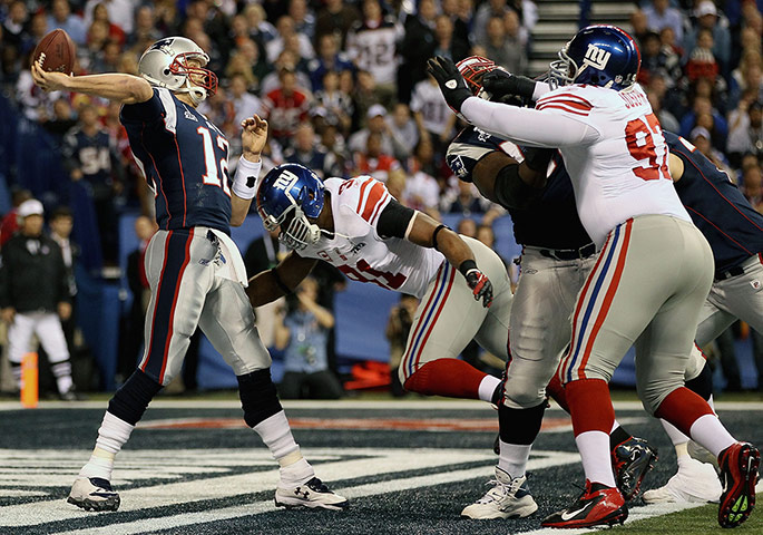 Superbowl: New England Patriots' Tom Brady is pressured in the endzone by Justin Tuck