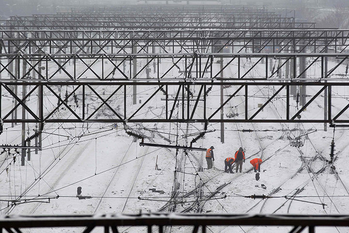 Europe weather: Workers clean tracks outside the snow-covered Railway Station, Bucharest