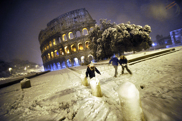 Europe weather: People playing in the snow in front of the ancient Colosseum in Rome