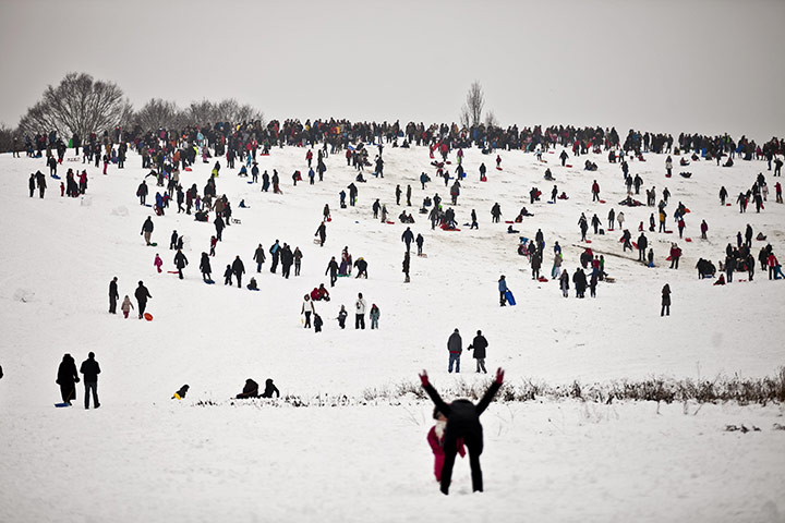Europe weather: People ride sledge on arliament Hill on Hampstead Heath, London