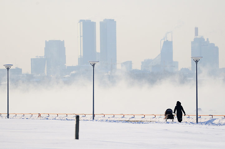 Europe weather: A woman walks with her baby along the frozen Tallinn bay, Estonia